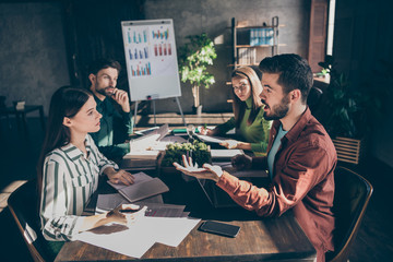 Experienced smart clever businesspeople specialists sharks company owners gathering talking about investment rate interest at modern industrial loft style interior work place station indoors