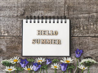 Beautiful, bright flowers lying on a white, wooden table. View from above, close-up