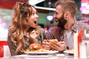 Screaming young loving couple using mobile phone.