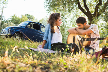 Beautiful couple in love having a picnic