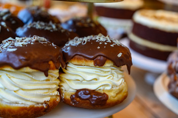 Scottish cream choux buns with chocolate close up