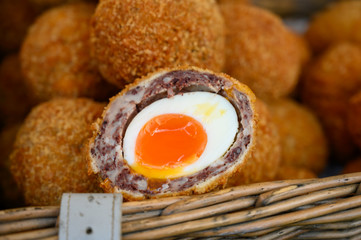 Traditional street food in UK, stuffed Scottish eggs with breadcrumbs