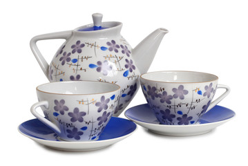 Vintage tea cups and teapot on table. Isolated objects on a white background