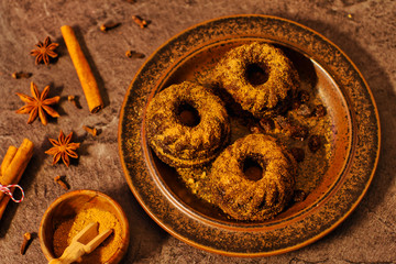 Mini bundt cakes with cinnamon, brown sugar in dark light from above