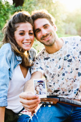 Beautiful couple taking a selfie having a picnic