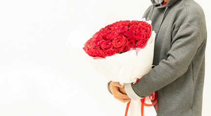 Red rose in man hand on white background,
