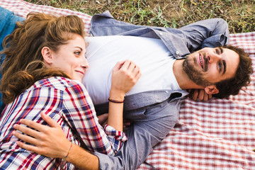 Couple in love on a blanket during a picnic outdoor