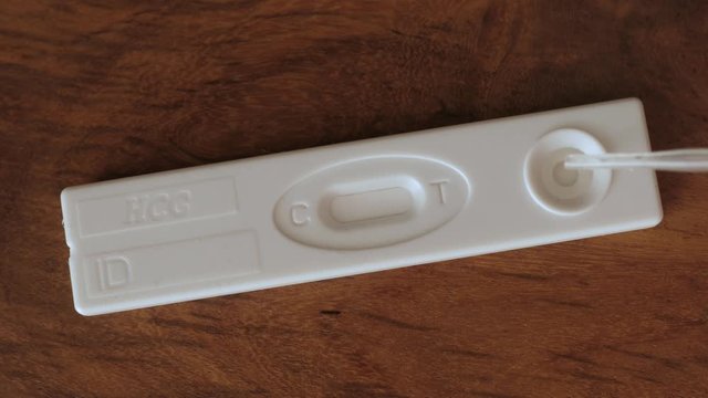 pregnancy test appears, appearing positive, dropping urine