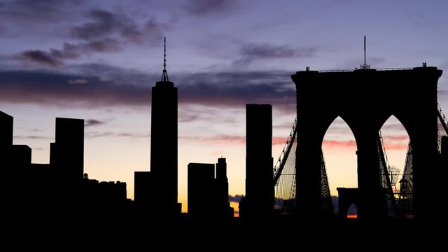 Manhattan: Time Lapse at Twilight with Bridge and Skyscrapers in Silhouette, New York City, USA