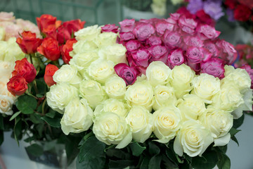 Colorful roses flowers behind the shop window. Valentine's day. Mother's Day! Holidays concept.
