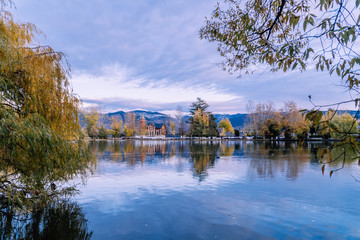 Obraz premium Puigcerdà, Catalonia / Spain. Lake of Puigcerdà with Villa Paulita and the snowy Pyrenees in the background