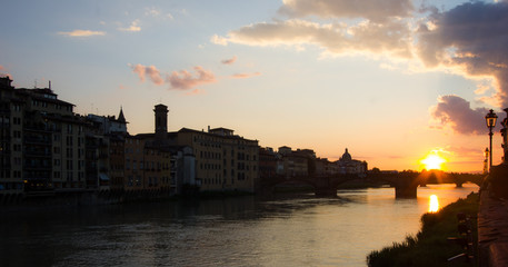 Naklejka premium sunset over town and river