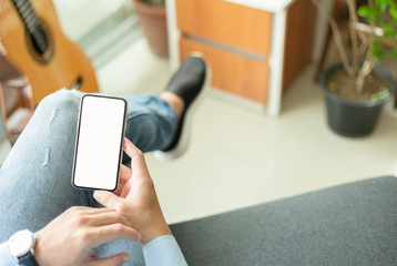 Mockup image blank white screen cell phone.woman hand holding texting using mobile on desk at coffee shop.background empty space for advertise text.people contact marketing business,technology 