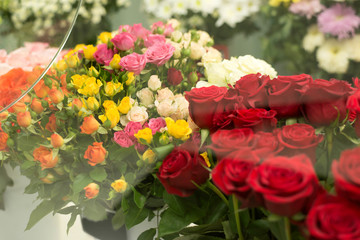 Colorful roses flowers behind the shop window. Valentine's day. Mother's Day! Holidays concept.
