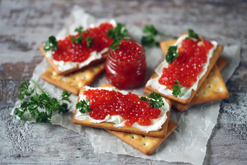 Crackers with white cheese and red caviar. Keto diet. Healthy breakfast. Keto snack.