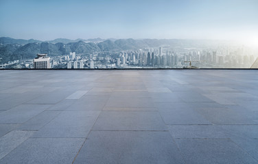 Square floor tiles and Chongqing urban building skyline..