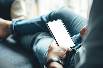 Mockup image blank white screen cell phone.woman hand holding texting using mobile on desk at coffee shop.background empty space for advertise text.people contact marketing business,technology 