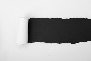 torn white paper frame on black backdrop