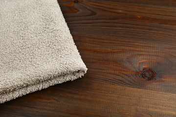 one clean towel on dark wooden background with copy space