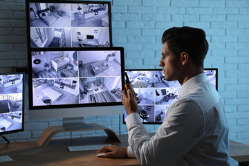 Male security guard with portable transmitter at workplace