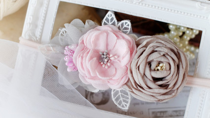 Headband flowers hair accessories with handmade floral design made out of floral fabric with soft pink and soft gray pastel color. A handmade craft great for DIY project content.