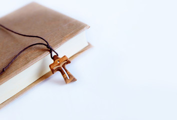 The wooden cross is a symbol and attribute of the Christian faith. Religious objects on a white background.