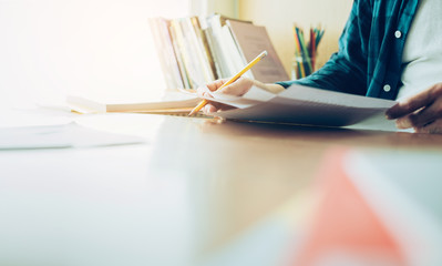 high school,university student study.hands holding pencil writing paper answer sheet.sitting lecture chair taking final exam attending in examination classroom.concept scholarship for education abroad