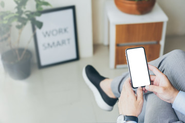 Mockup image blank white screen cell phone.woman hand holding texting using mobile on desk at coffee shop.background empty space for advertise text.people contact marketing business,technology 
