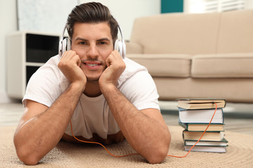 Man with headphones connected to book