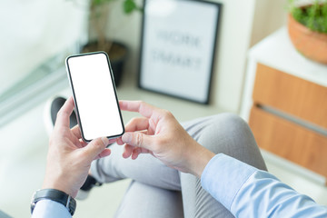 Mockup image blank white screen cell phone.man hand holding texting using mobile on desk at coffee shop.background empty space for advertise text.people contact marketing business,technology 
