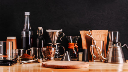 Defocused accessories and utensils for making coffee drinks ,wooden tray on foreground