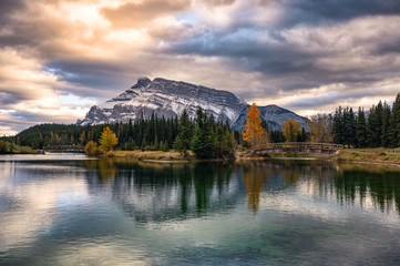 Cascade ponds with mount rundle and wooden bridge in autumn forest at Banff national park