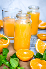 Naklejka na ściany i meble healthy morning with orange juice in bottle on kitchen background