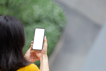 Mockup image blank white screen cell phone.woman hand holding texting using mobile.background empty space for advertise text.people contact marketing business,technology 