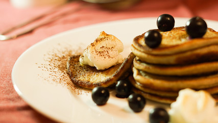 Pancakes with cocoa powder, bize and currant berry