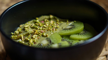 Avocado-pistachios mousse with slice kiwi