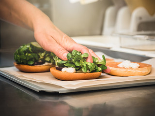 Preparation of burger. Professional chef is preparing burger. Burger making. Cooking hamburger concept.