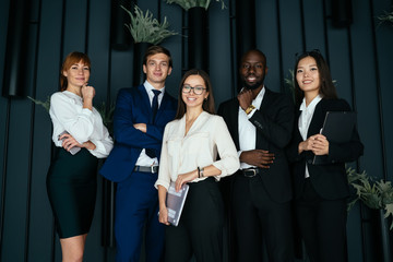 Joyful multiethnic colleagues in contemporary office
