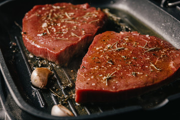 two steaks are fried in a pan. do-it-yourself dinner concept for two. eating at home.