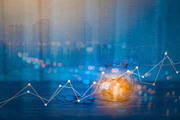Double exposure of Money coin stack growing graph with bokeh light background,investment concept. plant growing on coin, business finance and save money concept.
