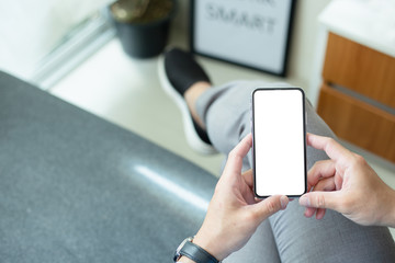 Mockup image blank white screen cell phone.woman hand holding texting using mobile on desk at coffee shop.background empty space for advertise text.people contact marketing business,technology 