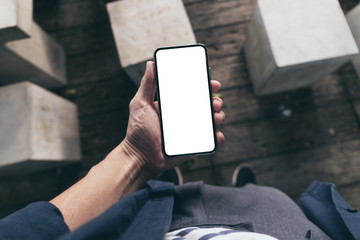Mockup image blank white screen cell phone.woman hand holding texting using mobile on desk at coffee shop.background empty space for advertise text.people contact marketing business,technology 