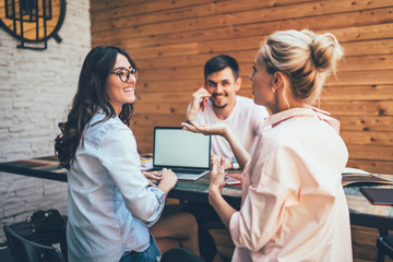 Modern laughing women collaborating on new project