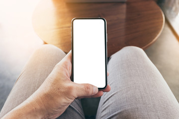 Mockup image blank white screen cell phone.woman hand holding texting using mobile on desk at coffee shop.background empty space for advertise text.people contact marketing business,technology 
