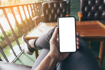 Mockup image blank white screen cell phone.woman hand holding texting using mobile on desk at coffee shop.background empty space for advertise text.people contact marketing business,technology 