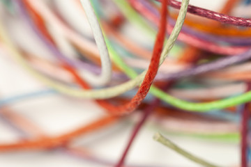 Messy multicolor threads with one infront white background