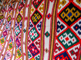 Colorful and oriental shapes on the carpet rug presented in eastern style and made of natural wool with national and ethnic significance