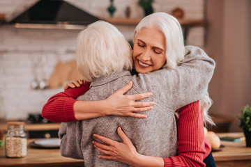 Two mature grey-haired positive ladies feeling wonderful