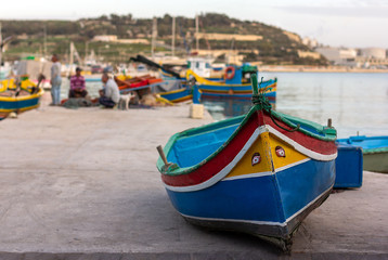 Traditional maltese boat in harbour in sunny day in Marsaxlokk fishers village