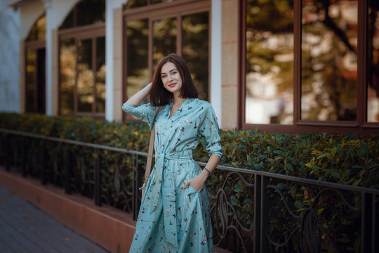 Fashion portrait of young stylish woman walking on the street
